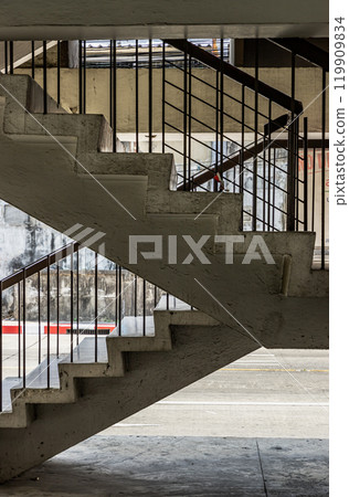Side view of Old concrete staircases with railings pattern in the old apartment building architecture. 119909834