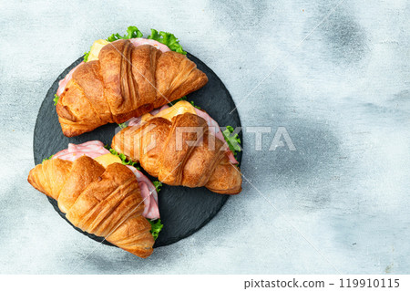 Croissant sandwich with salad ham and cheese . Top view 119910115