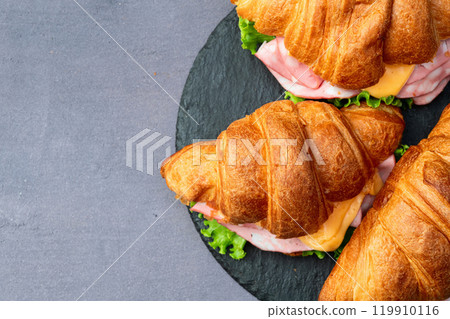 Croissant sandwich with salad ham and cheese . Top view 119910116