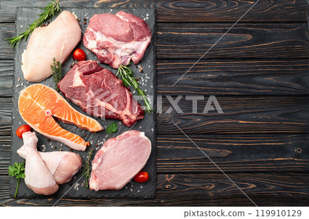 Mix of raw meat and fish . Salmon , beef , pork , chicken staek . Top view 119910129