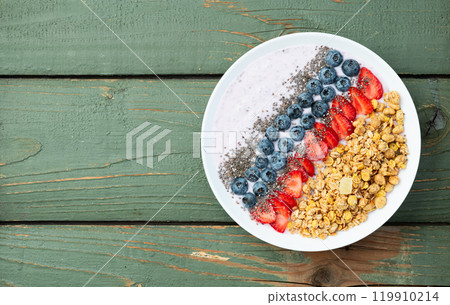 Healthy breakfast . Yogurt with berries ( strawberry , raspberry , blueberry , blackberry ) , granola and chia seeds . Top view 119910214