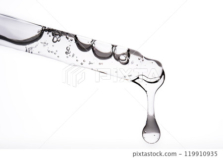 Dropper pipette with delicious serum with bubbles close-up. Dropper pipette with delicious serum with bubbles close-up. 119910935