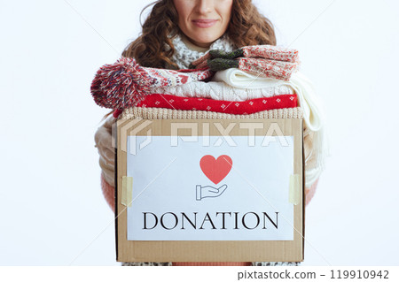 Trendy 40 years old woman in sweater, mittens, hat and scarf Trendy 40 years old woman in sweater, mittens, hat and scarf 119910942