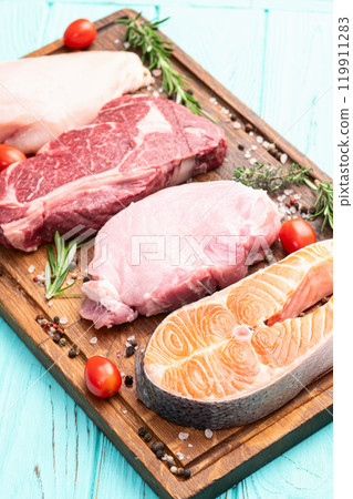 Mix of raw meat and fish . Salmon , beef , pork , chicken staek . Top view 119911283