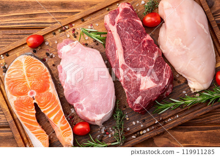 Mix of raw meat and fish . Salmon , beef , pork , chicken staek . Top view 119911285