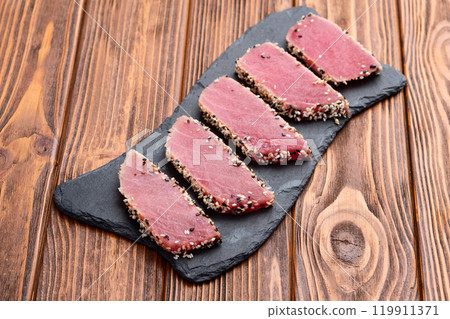 Sliced tuna steak with sesame photography . Top view 119911371