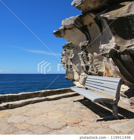 Bench, rock and blue Pacific Ocean in Sydney, Australia. Bench, rock and blue Pacific Ocean in Sydney, Australia. 119911496