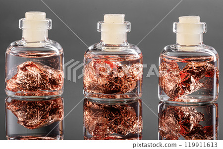 macro metal copper in a capsule on a gray background 119911613