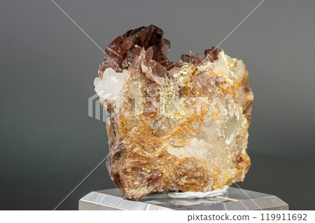 Macro minerals Axinite stone on a gray background 119911692