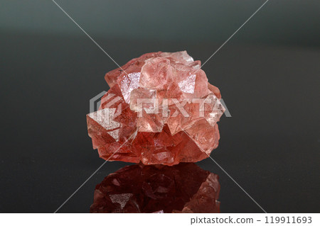macro mineral stone pink fluorite on a black background 119911693
