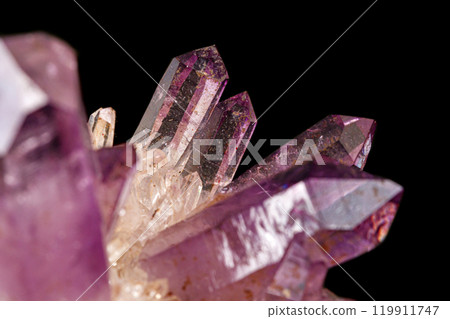 Macro of amethyst mineral stone on black background 119911747