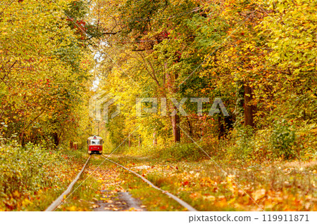 Autumn forest through which an old tram rides (Ukraine) Autumn forest through which an old tram rides (Ukraine) 119911871