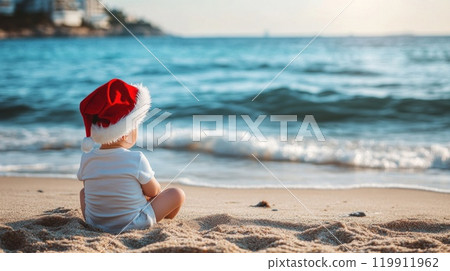 Back view of toddler in Santa hat sitting on beach 119911962
