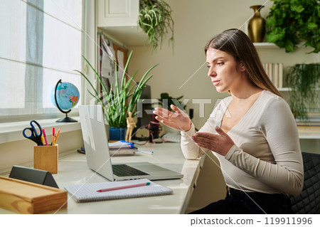 Young woman university student studying using laptop computer for video chat 119911996
