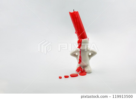 Red candle stub in cute candlestick closeup on white 119913500