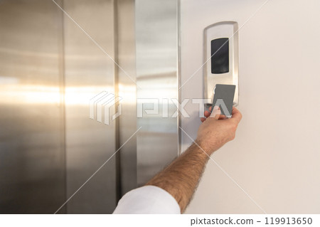 Woman hand holding mockup key card to lock and Woman hand holding mockup key card to lock and 119913650