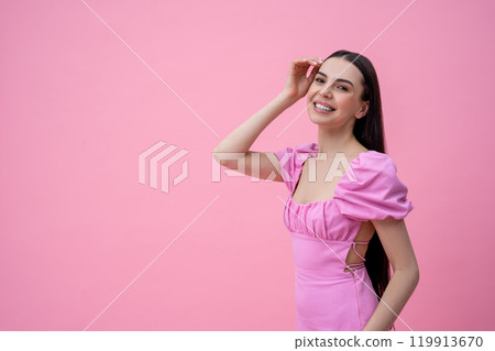 Excited young cute dark-haired young woman on a pink background 119913670