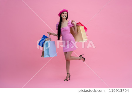 Energetic young cute woman in pink beret with shopping bags Energetic young cute woman in pink beret with shopping bags 119913704