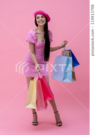 Pretty happy young woman in pink after shopping Pretty happy young woman in pink after shopping 119913706