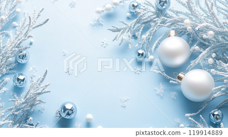 Christmas frame from frosty white branches, silver and white ornaments, and delicate snowflakes on a soft blue background Christmas frame from frosty white branches, silver and white ornaments, and delicate snowflakes on a soft blue background 119914889