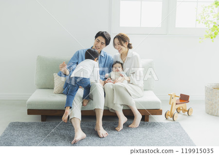 Young family, parents and children, living room 119915035