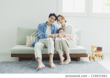 Young family, parents and children, living room 119915061