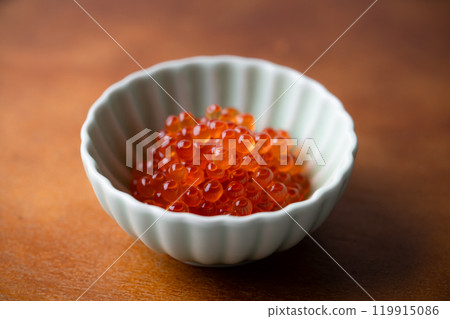 Salmon roe marinated in soy sauce served in a small bowl Salmon roe marinated in soy sauce served in a small bowl 119915086