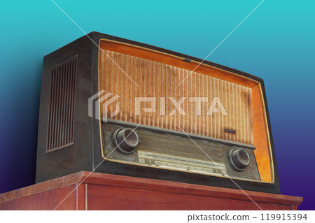 antique and old brown radio on old red wooden table,  blue and green gradient wall background, object, ancient, decor, fashion, template, copy space 119915394