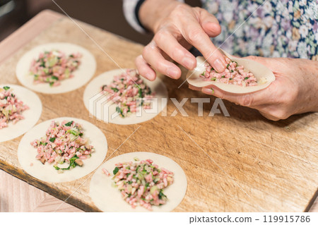 Senior woman making dumplings Senior woman making dumplings 119915786