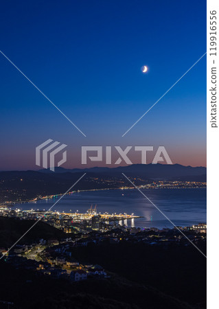 Night view from Windmill Hill in Wellington, New Zealand and a crescent moon in the morning sky 119916556
