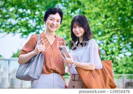 Business woman operating a smartphone Business woman operating a smartphone 119916876