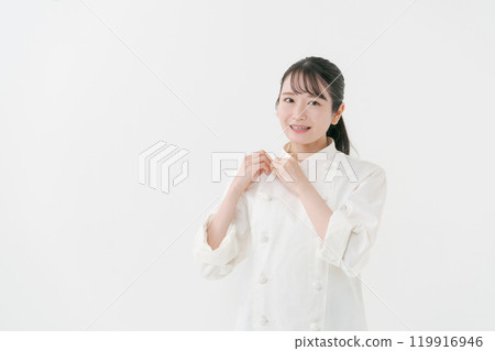 Portrait of a female chef wearing a chef's coat 119916946