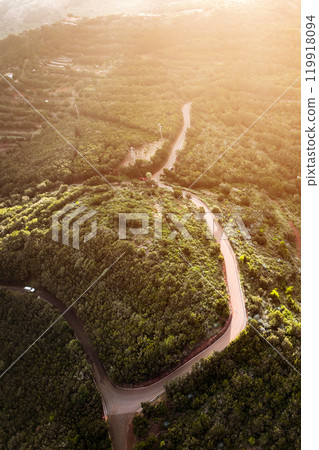 A landscape with a road and valleys among the mountains at sunset, the  119918094