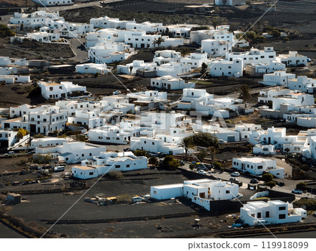 White buildings, town among volcanic black mountains and lava formations in White buildings, town among volcanic black mountains and lava formations in 119918099