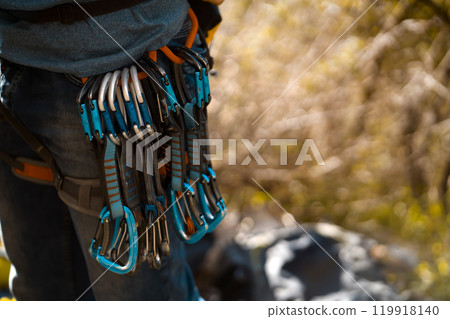 Rock climder with climbing equipment, quick draws. Rock climder with climbing equipment, quick draws. 119918140