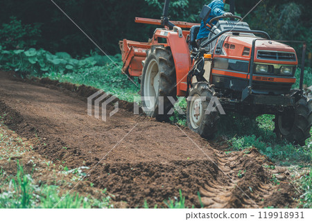 Tractor and farmer 119918931