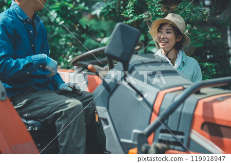 Tractor experience: A woman learning how to drive a tractor Tractor experience: A woman learning how to drive a tractor 119918947