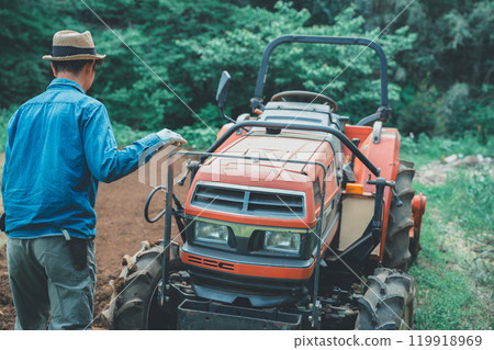 Tractor and farmer 119918969