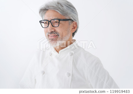 Senior man wearing a chef's coat Senior man wearing a chef's coat 119919483