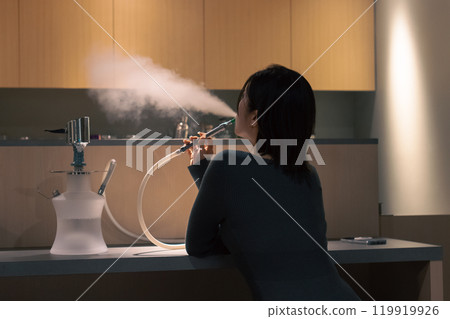 Woman enjoying shisha Woman enjoying shisha 119919926