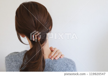 女人抱著肩膀,肩膀僵硬 女人抱著肩膀,肩膀僵硬 119920547