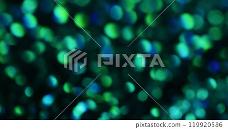 Blurred flare. Colored highlights. Festive iridescence of blinked spots dark surface. Bright speckled kaleidoscope with different power spotlight. 119920586