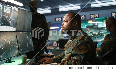 Military officer in command post receiving intel folder files on enemy battle formation. Intelligence specialist reading mission case file to collect data on opponents strategy, camera B 119920884