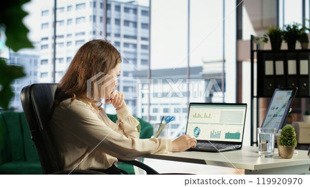 Ambitious female leader developing a strategic plan for business growth, aligning the company efforts with the enterprise vision and market opportunities for global expansion. Camera B. 119920970