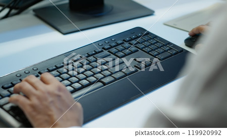 Admin in data center designing, implementing and managing gear to ensure optimal performance and reliability. Close up of expert typing on keyboard in server room, coding on computer, camera A 119920992