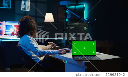 Admin using green screen laptop to implement security measures, protecting company systems and data. IT worker testing and debugging code for software applications on chroma key notebook, camera B 119921042
