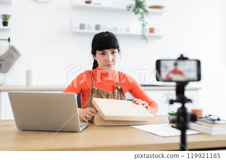 Caucasian female blogger live streaming unboxing experience online Caucasian female blogger live streaming unboxing experience online 119921185