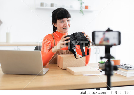 Caucasian female blogger unboxing new virtual reality headset online Caucasian female blogger unboxing new virtual reality headset online 119921191