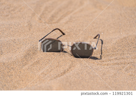 Sunglasses on the sand, giving a summer feel Sunglasses on the sand, giving a summer feel 119921301