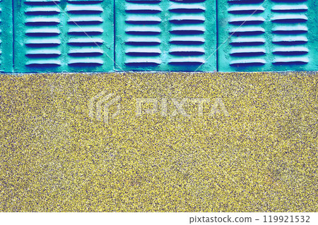 Old azure emerald grille ventilation holes lattice, wall with stone chips 119921532